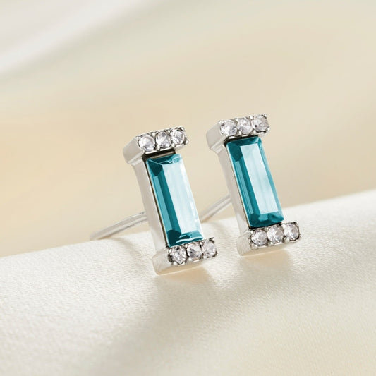 Sterling silver stud earring with aquamarine blue baguette shaped stone with pavé settings