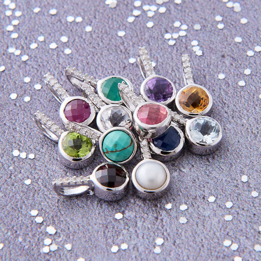 Faceted birthstone pendants with white diamonds in sterling silver by Claudette Worters