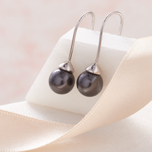 Black pearl drop earrings in sterling silver by Claudette Worters