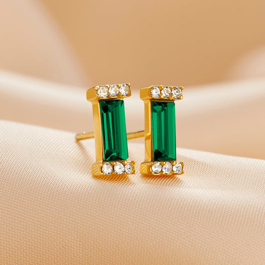 Gold emerald earrings with baguette cut green emerald Swarovski crystal stones in an Art Deco style setting by Claudette Worters.