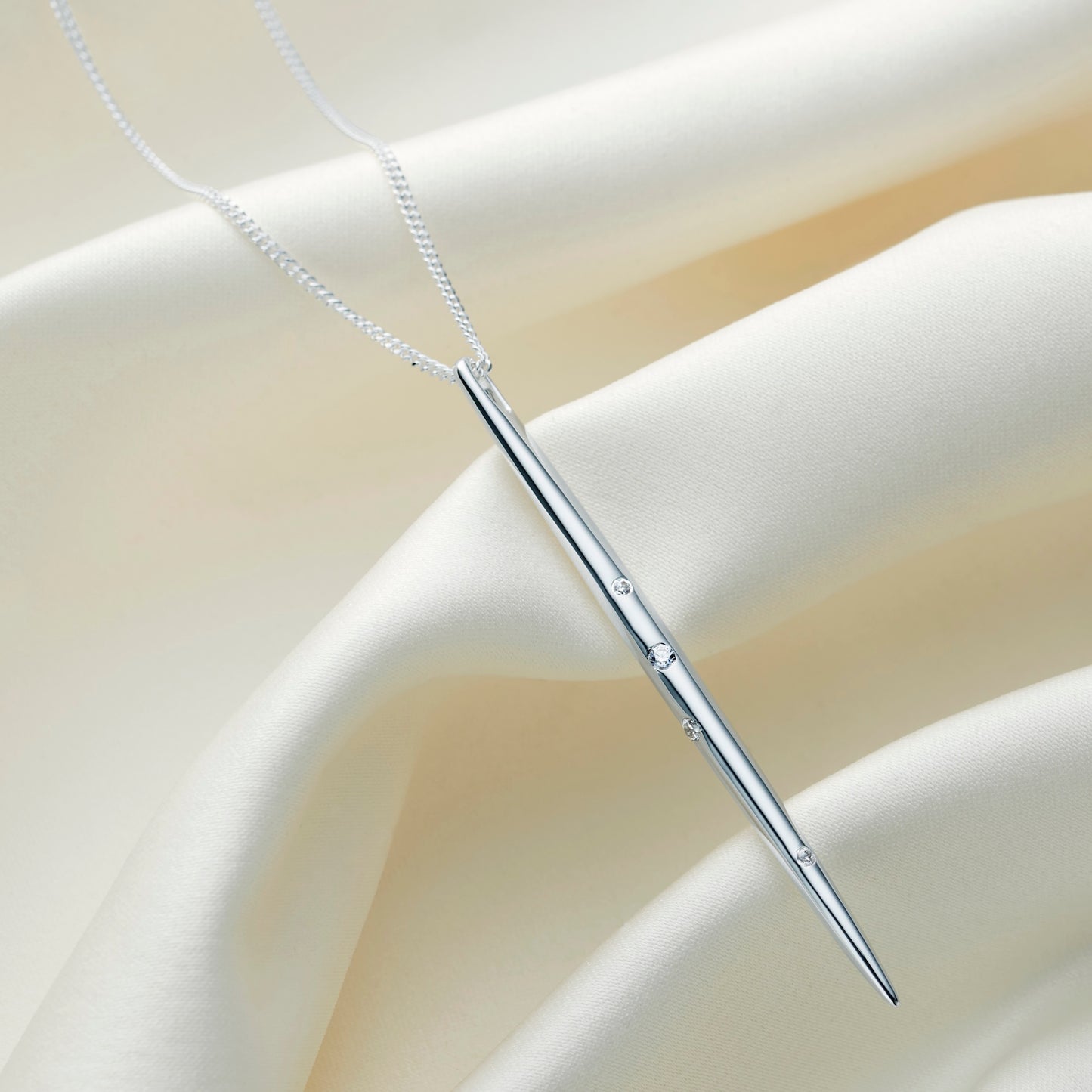 Zodiac constellation necklace in the star sign of Gemini. Featuring a long sterling silver spike pendant, set with Swarovski crystals in the formation of the Gemini constellation on a fine silver chain.