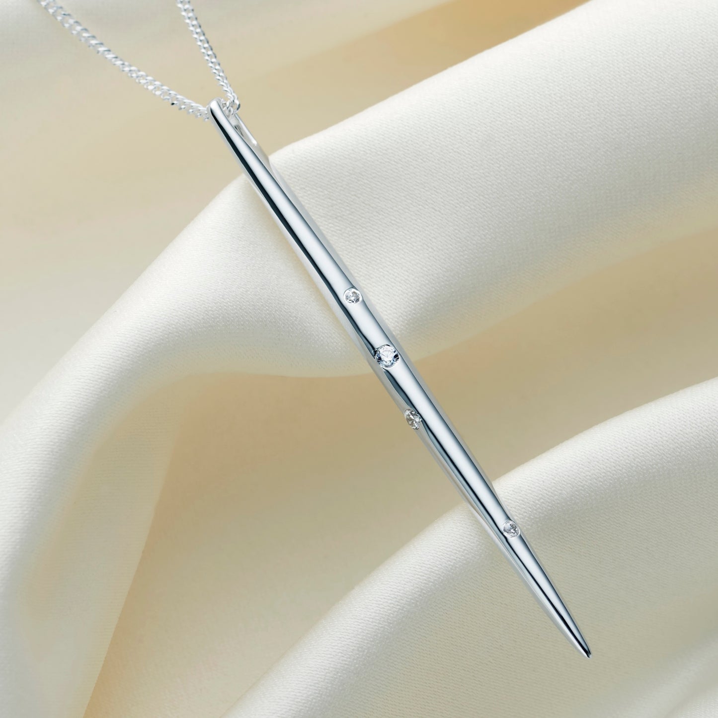 Sterling silver Gemini constellation necklace. Long thin spike style pendant, set with white crystals in the formation of the Gemini star constellation.