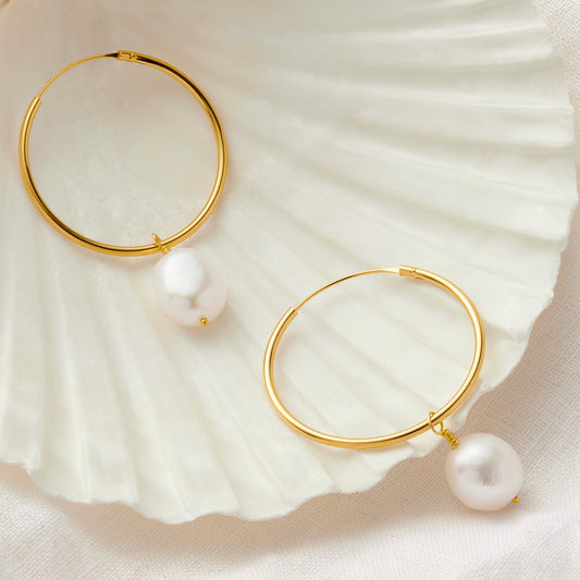 Large gold hoop earrings with white pearls