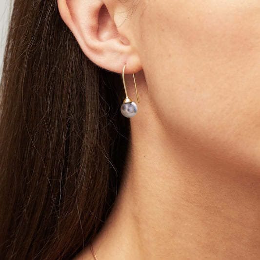 Single round grey pearl drop earrings on gold prong