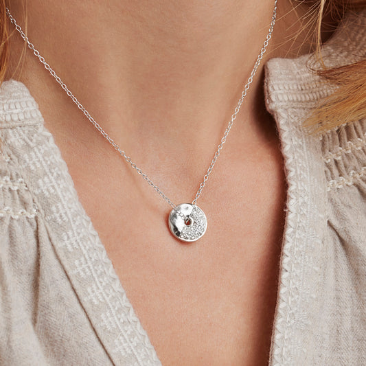 Silver moon phase necklace with a round pendant, set with genuine natural diamonds to illustrate the First Quarter with a fine silver chain threaded through the centre of the pendant
