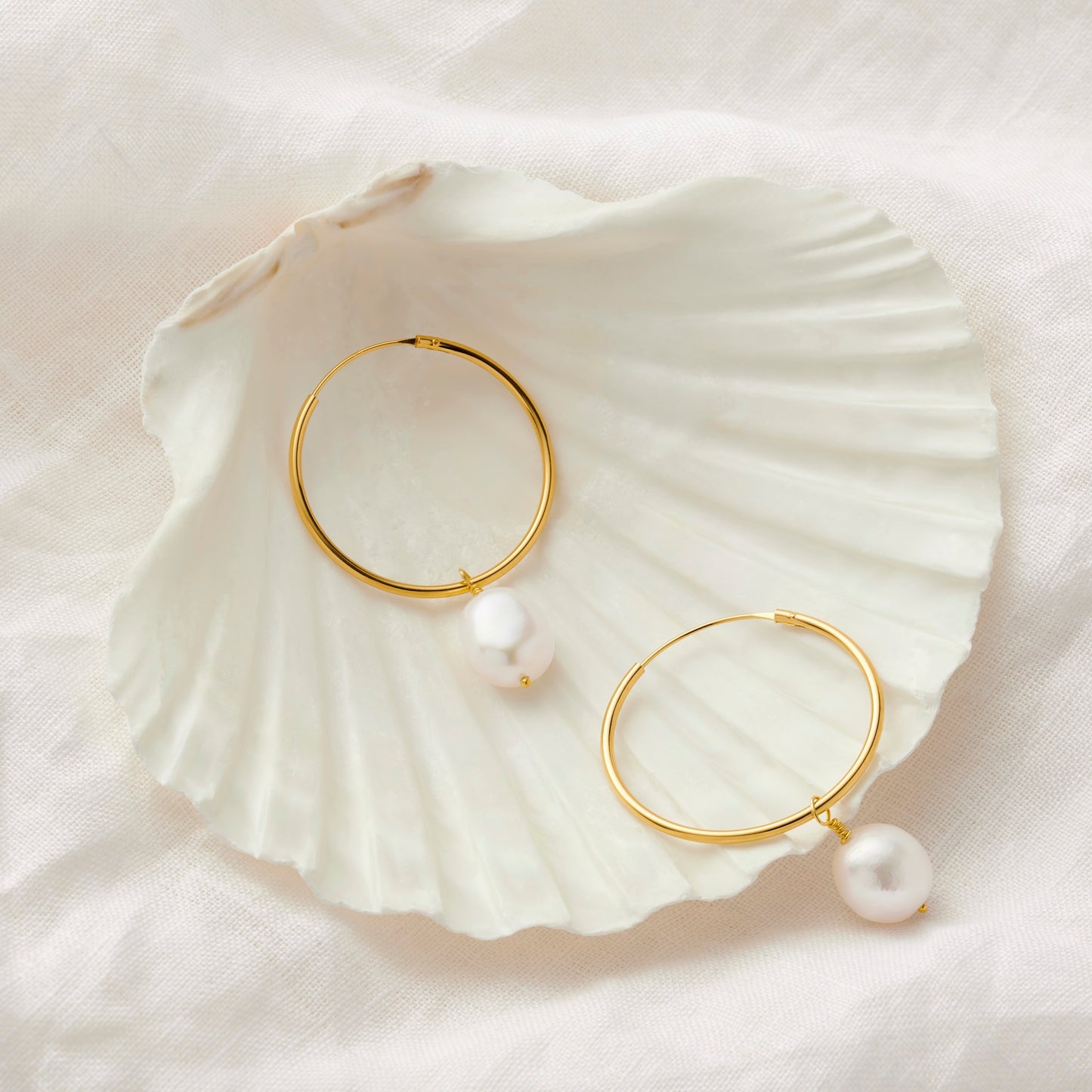 Pair of gold hoop pearl earrings