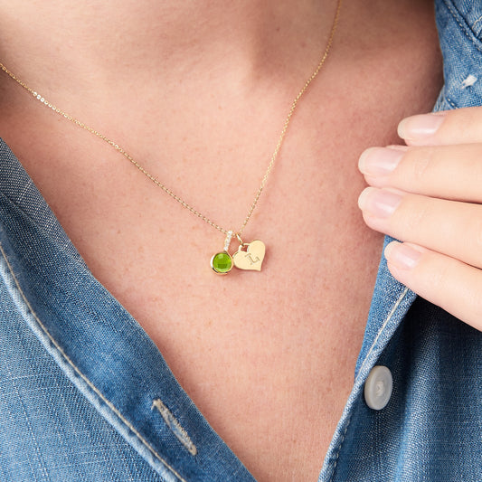 Green peridot gemstone pendant in 18 carat yellow gold vermeil with a heart charm personalised with an initial on a fine gold chain