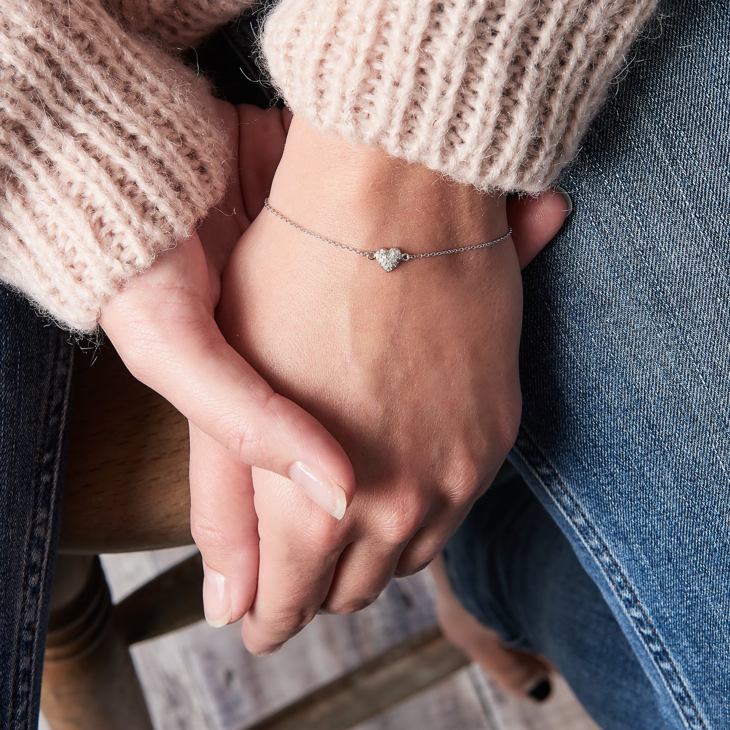Sterling silver bracelet with a pretty heart charm set with real tiny white diamonds. Heart charm is on a delicate sterling silver trace chain by Claudette Worters.