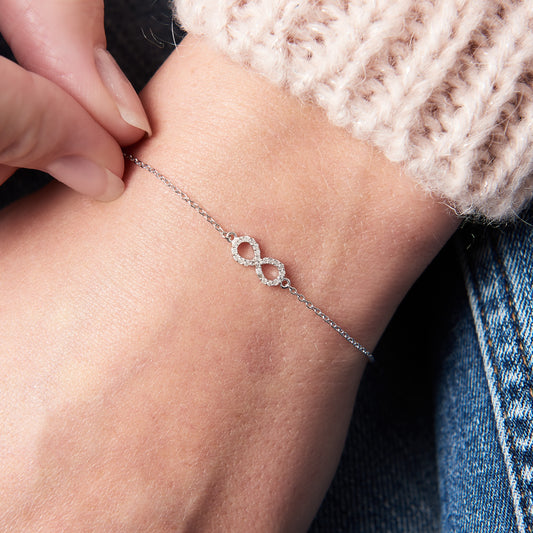 Silver infinity bracelet set with tiny white diamonds on a delicate sterling silver trace chain.