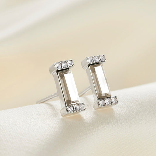 Sterling silver stud earrings with faceted clear crystal baguette stones in little pavé crystal settings.