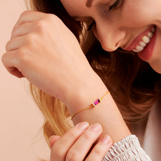 Ruby birthstone gold bracelet with faceted baguette cut Ruby birthstone for July.