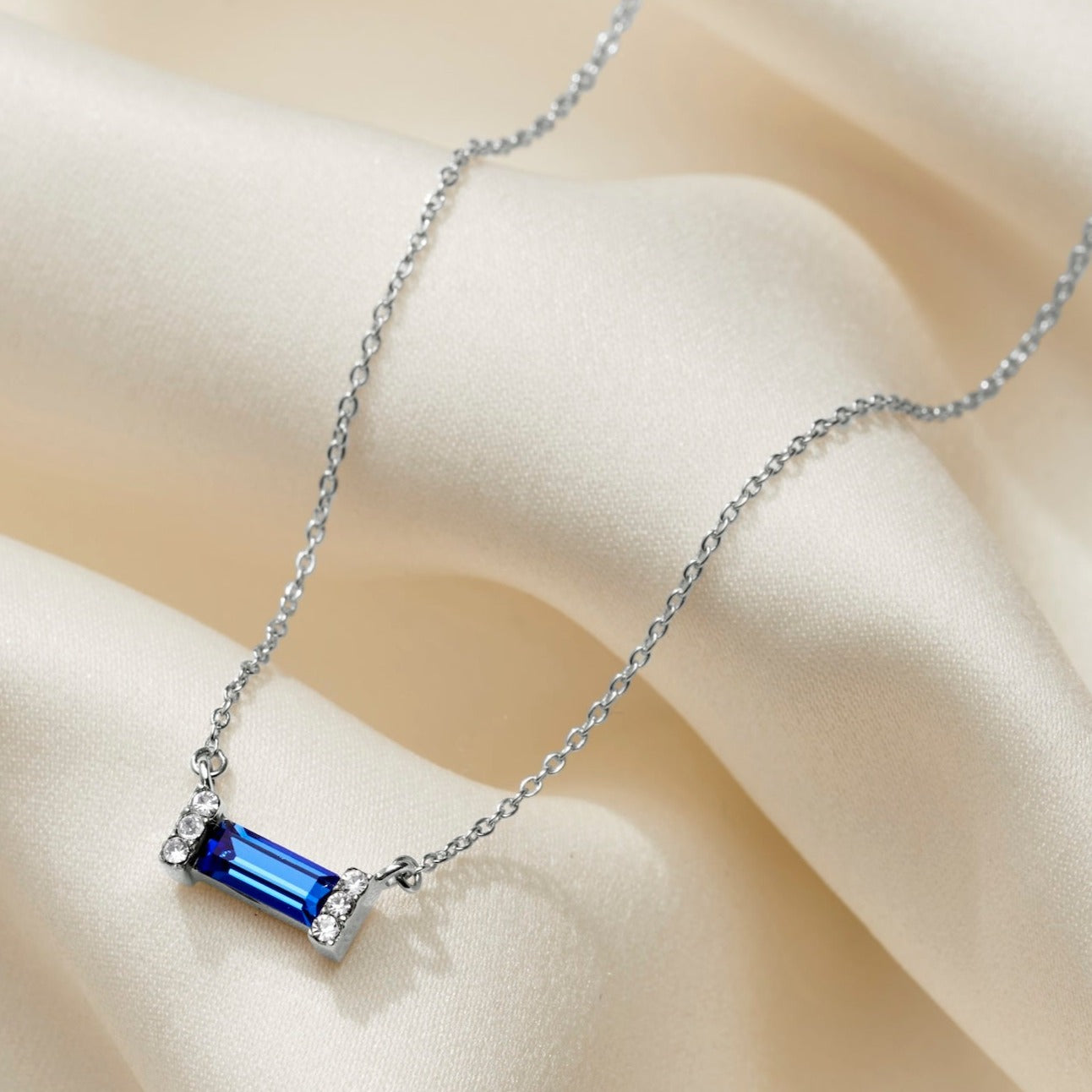 Bright sapphire blue necklace with a baguette shaped blue sapphire crystal on a dainty silver trace chain.