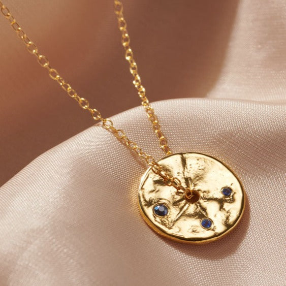 September Sapphire Spinner necklace in gold vermeil, with blue sapphires on a fine gold trace chain.