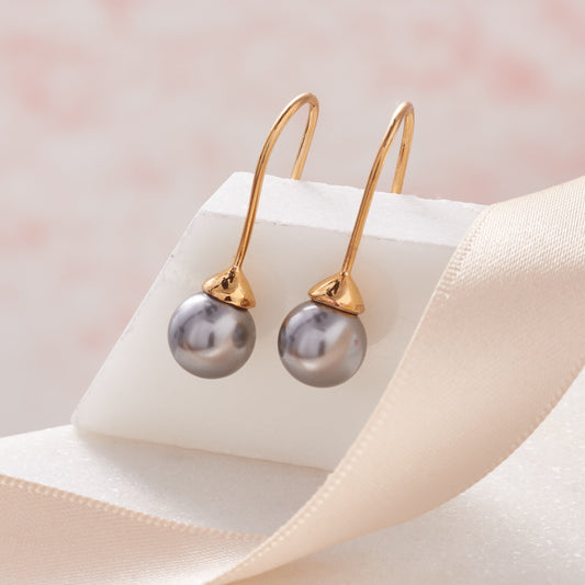 Grey pearl drop earrings in gold by Claudette Worters