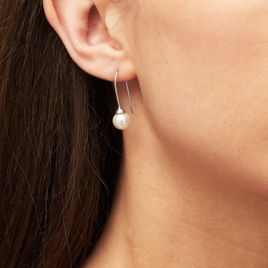 Ivory pearl earrings in sterling silver with long hook by Claudette Worters