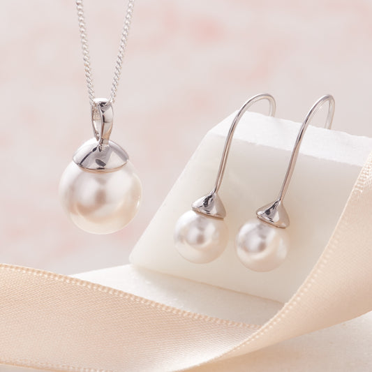 Large white pearl pendant and matching white pearl drop earrings in sterling silver.