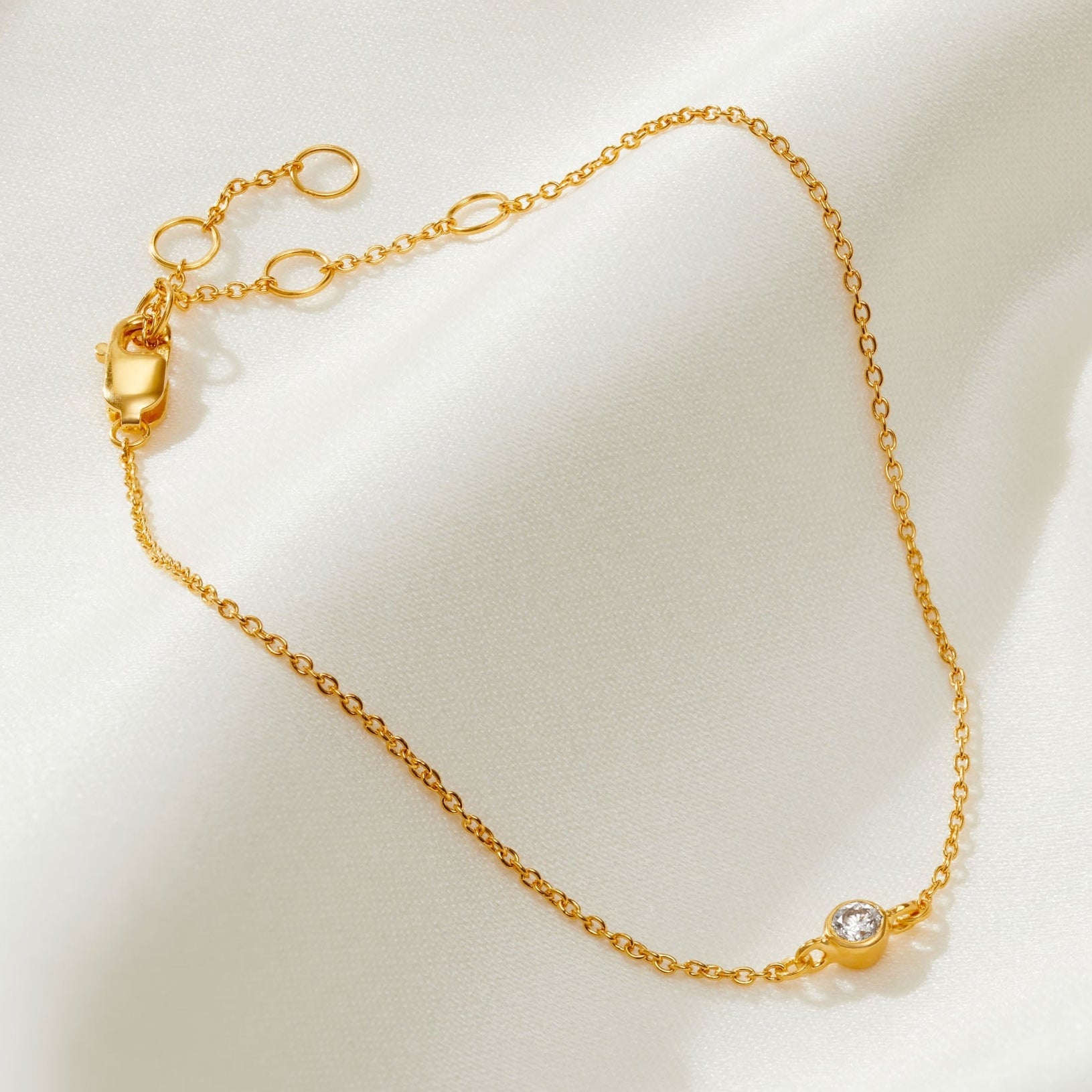 21st birthday diamond bracelet with single diamond on a fine gold trace chain