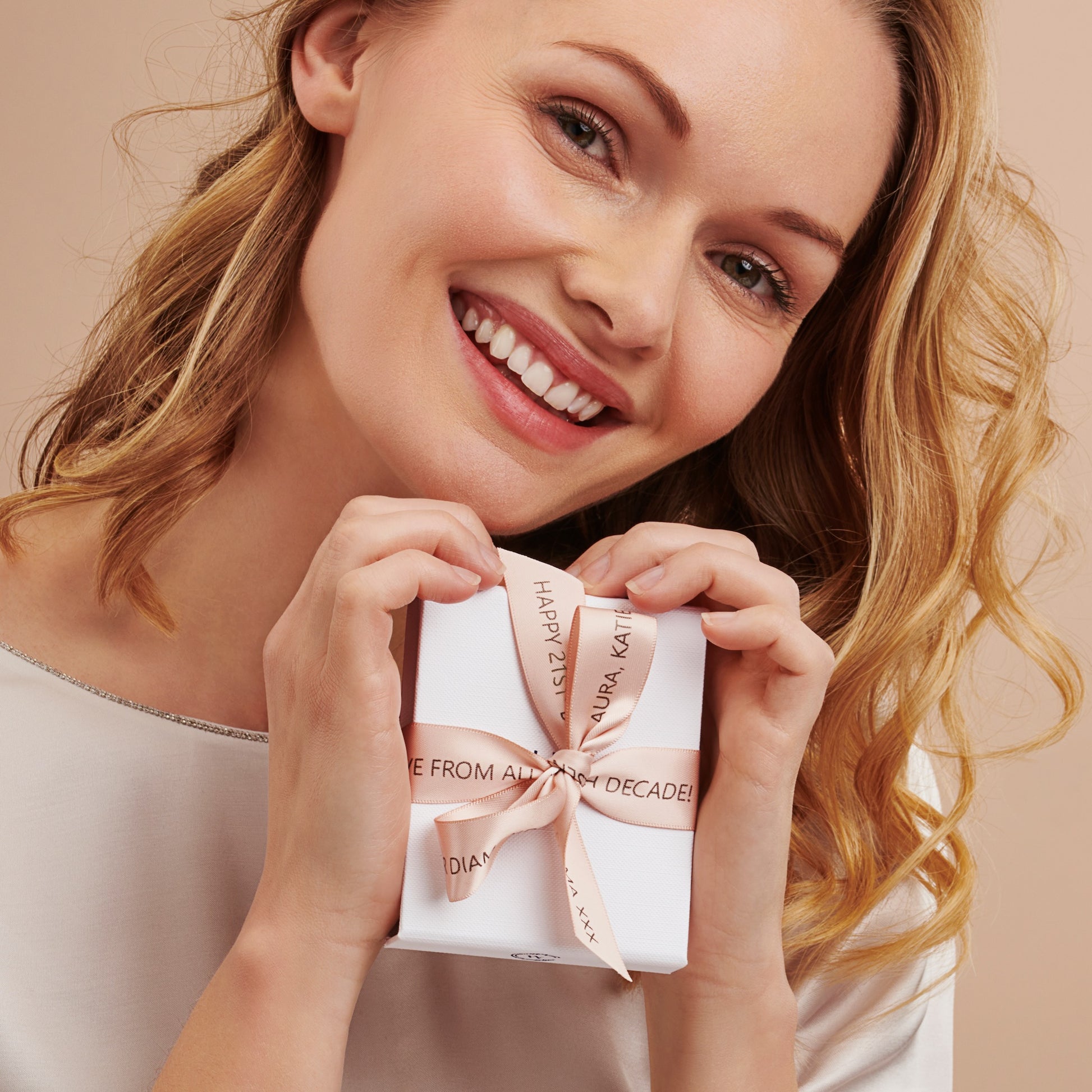 21st birthday bespoke ribbon in pale pink with personal message tied in a bow on a white gift box