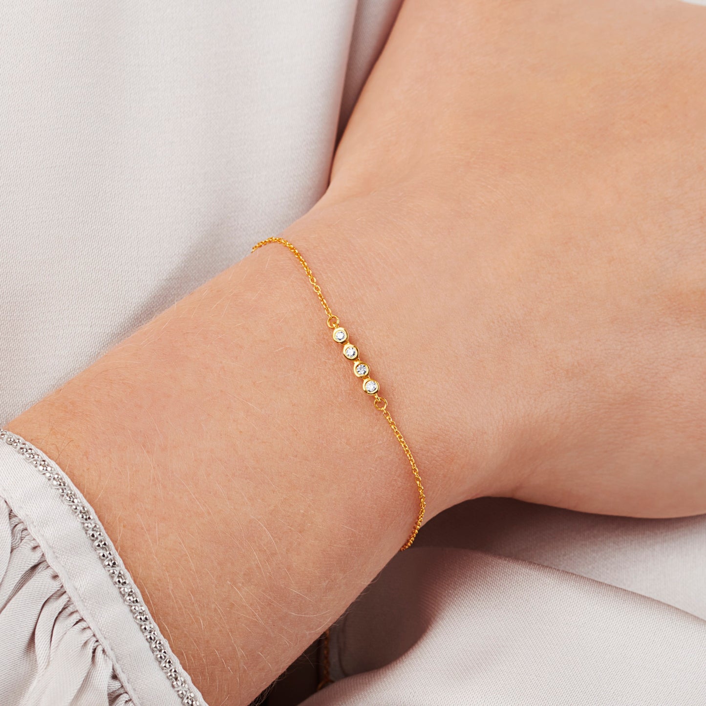40th birthday diamond bracelet with 4 diamonds in rub over settings on a fine trace chain in gold vermeil