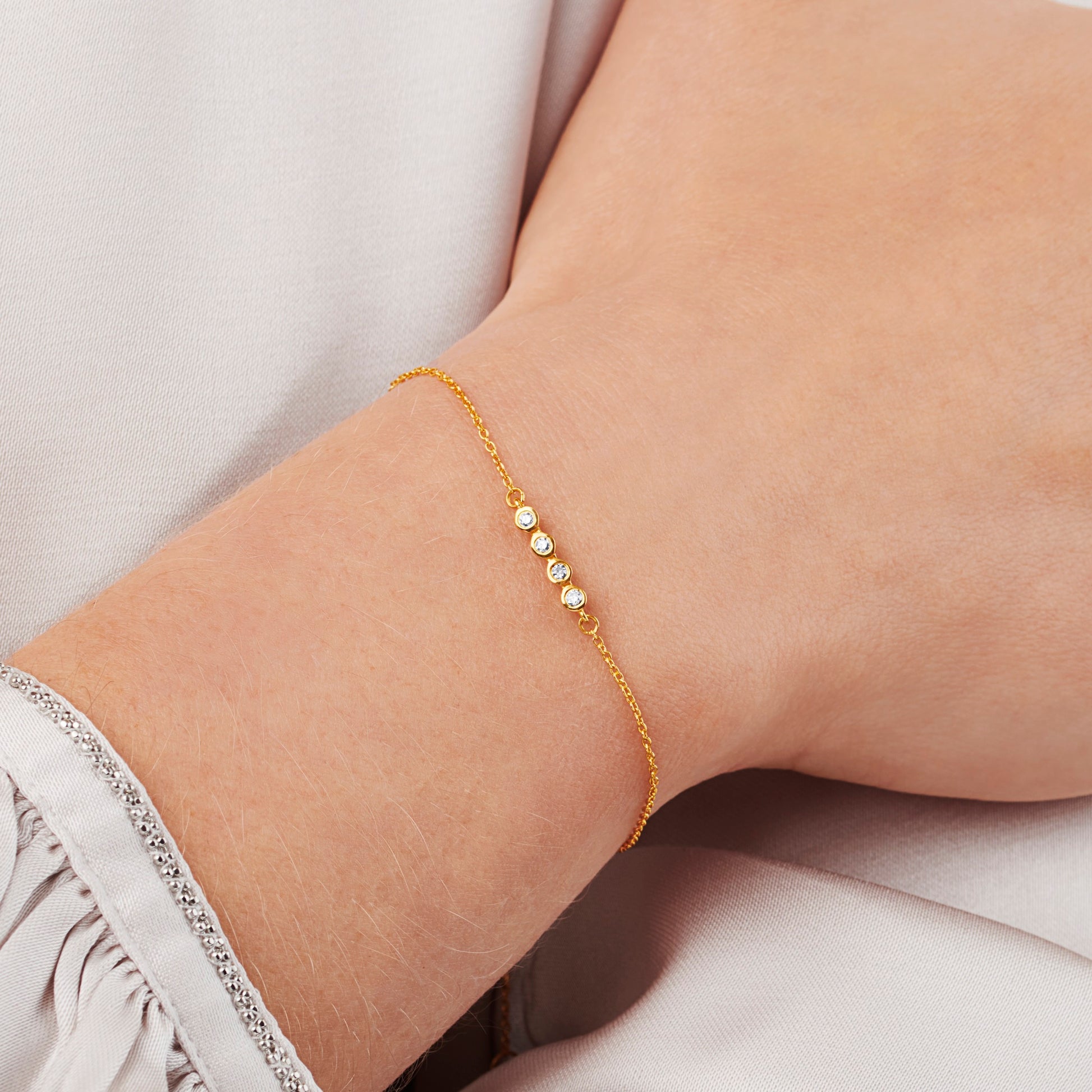 40th birthday diamond bracelet with 4 diamonds in rub over settings on a fine trace chain in gold vermeil