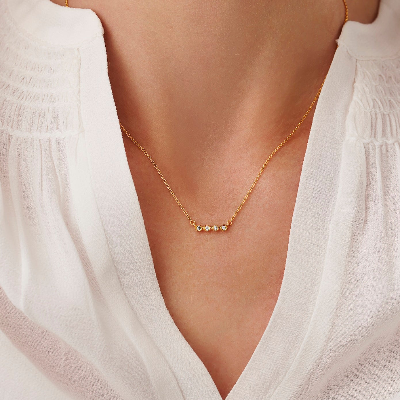 40th birthday diamond necklace with 4 diamonds set side by side in gold vermeil on a dainty trace chain in gold vermeil