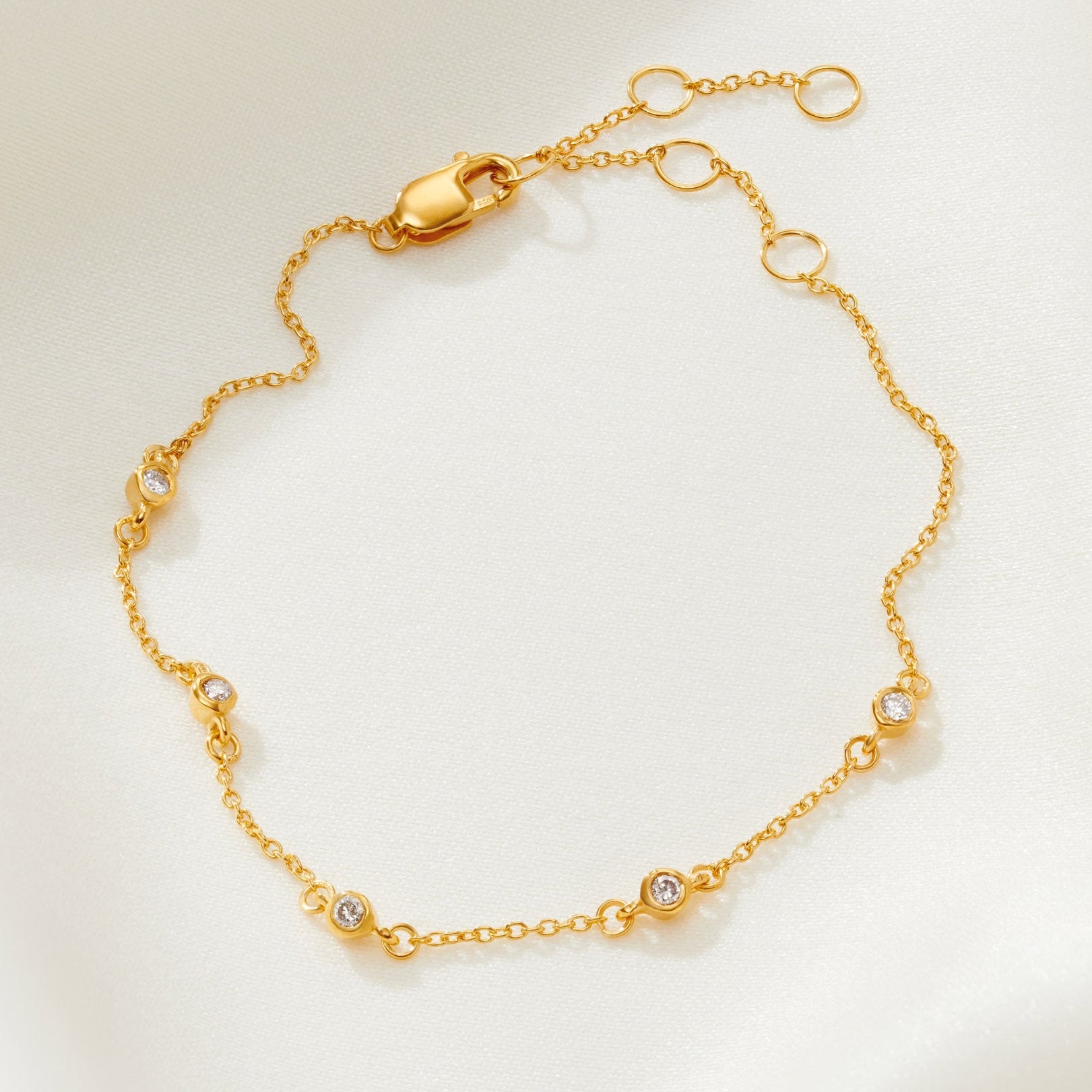 50th birthday bracelet with 5 bezel set diamonds in gold vermeil on a dainty trace chain and lobster claw fastening 