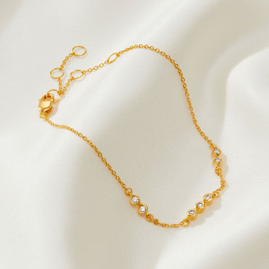 70th birthday diamond bracelet in gold with 7 natural diamonds in rub over settings on a dainty trace chain