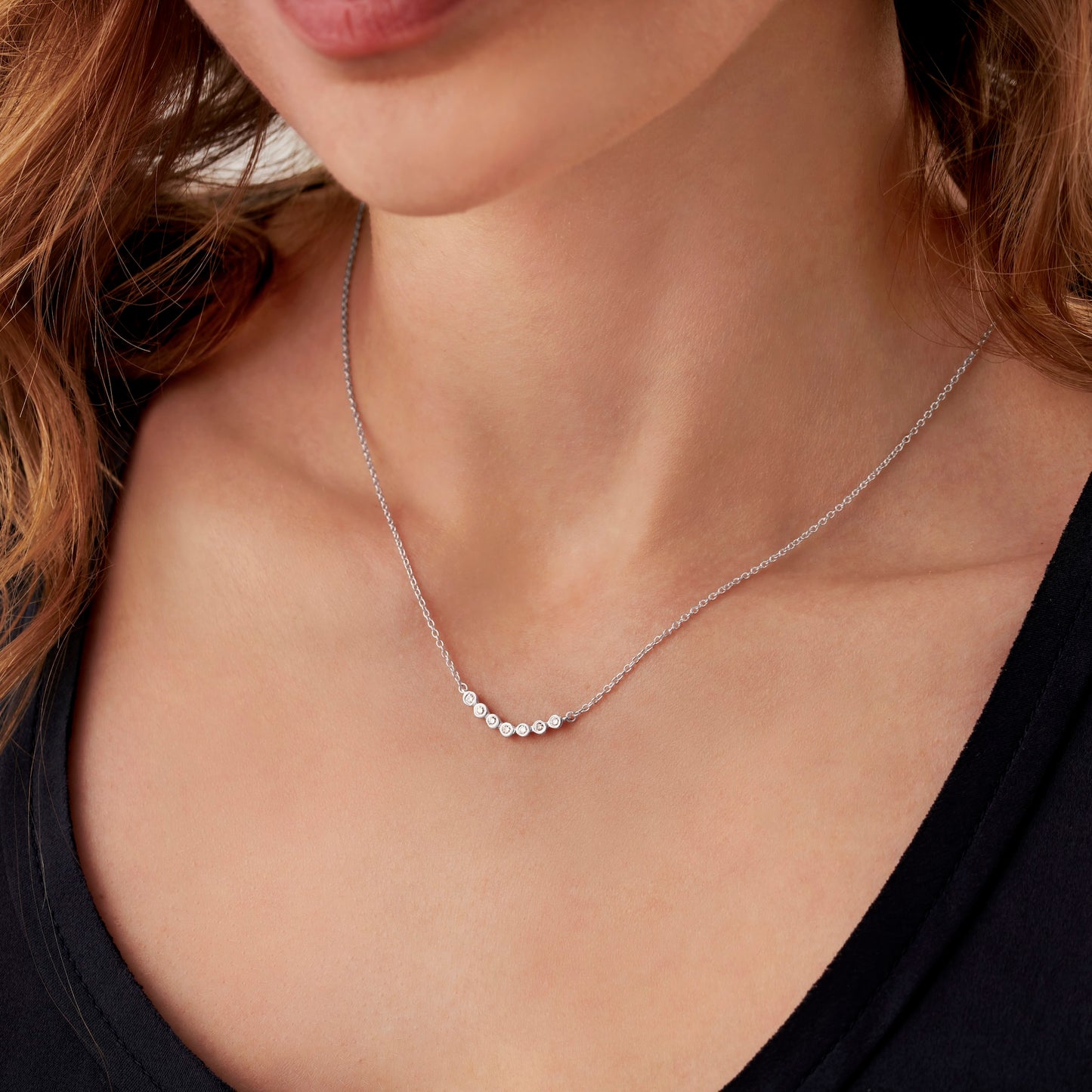 70th birthday necklace with 7 round diamonds in sterling silver on a dainty trace chain