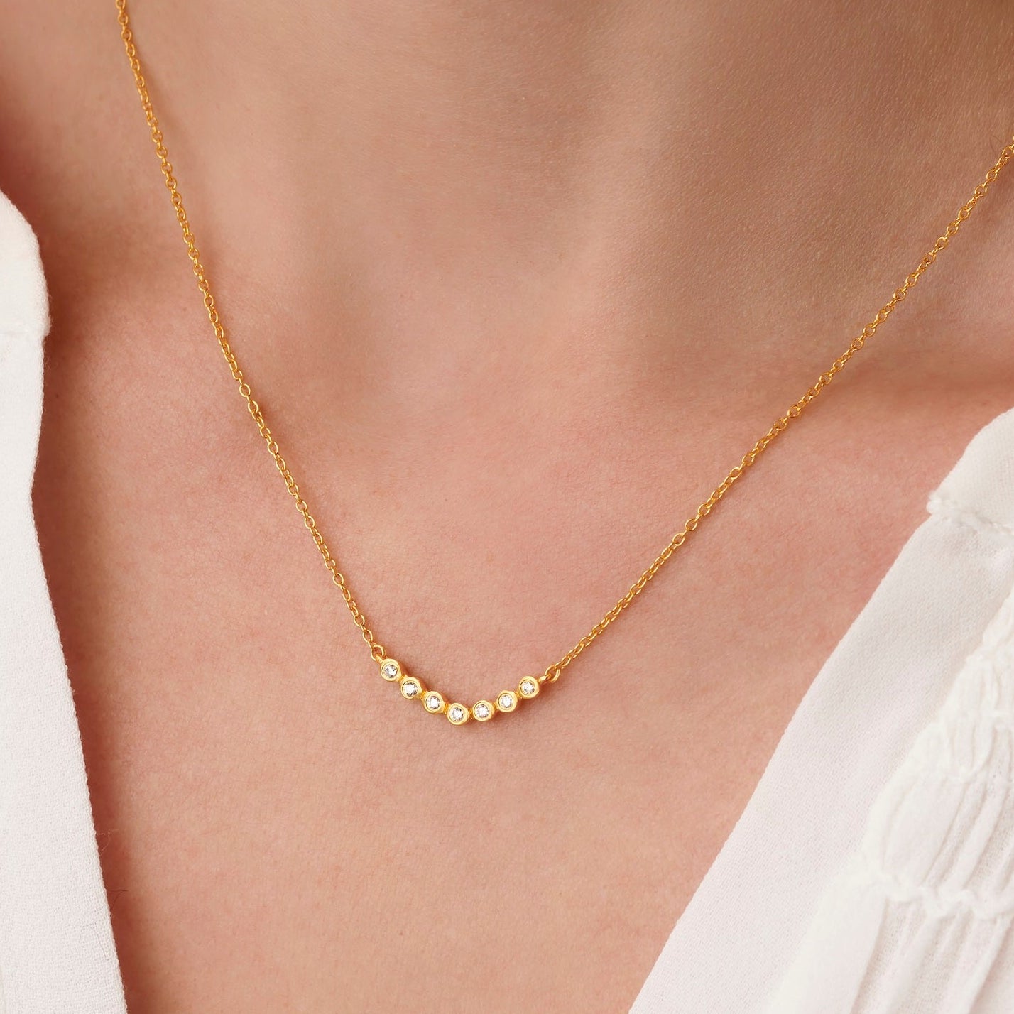 70th birthday womens necklace in gold with 7 diamonds for each decade by Claudette Worters