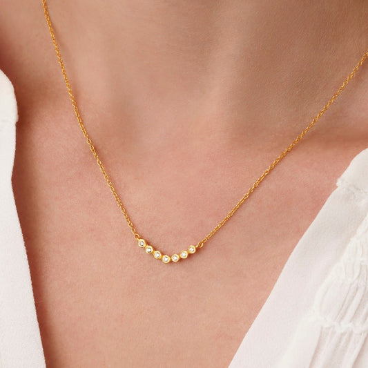 70th birthday womens necklace in gold with 7 diamonds for each decade by Claudette Worters