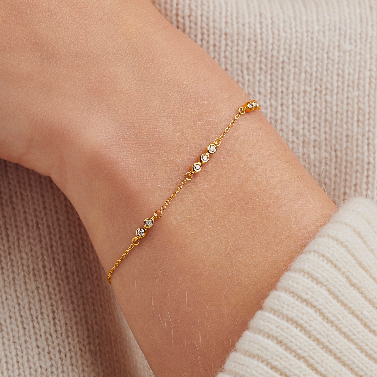 Diamond bracelet with 7 bezel set round diamonds in gold vermeil and a dainty trace chain for 70th birthday gift