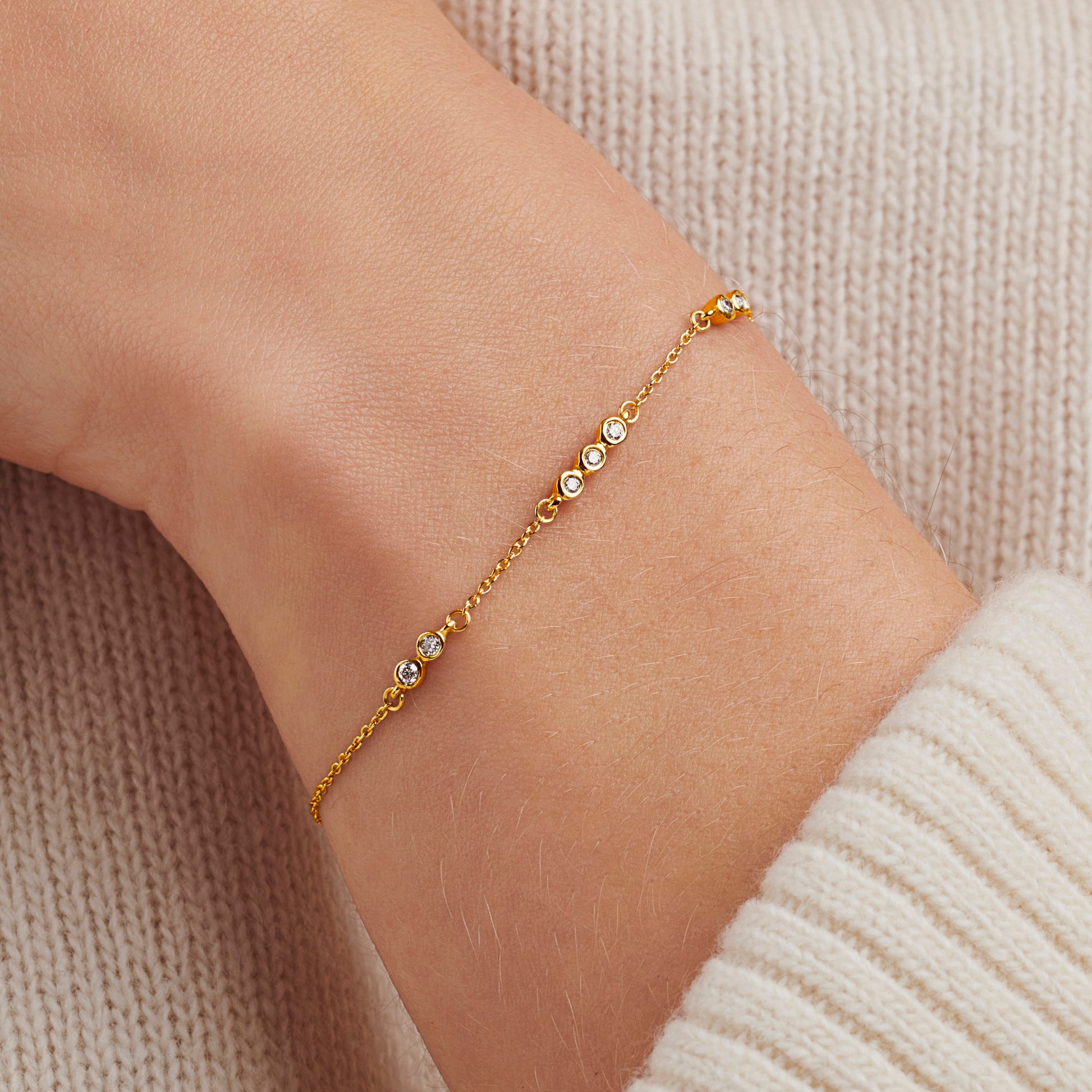 Diamond bracelet with 7 bezel set round diamonds in gold vermeil and a dainty trace chain for 70th birthday gift