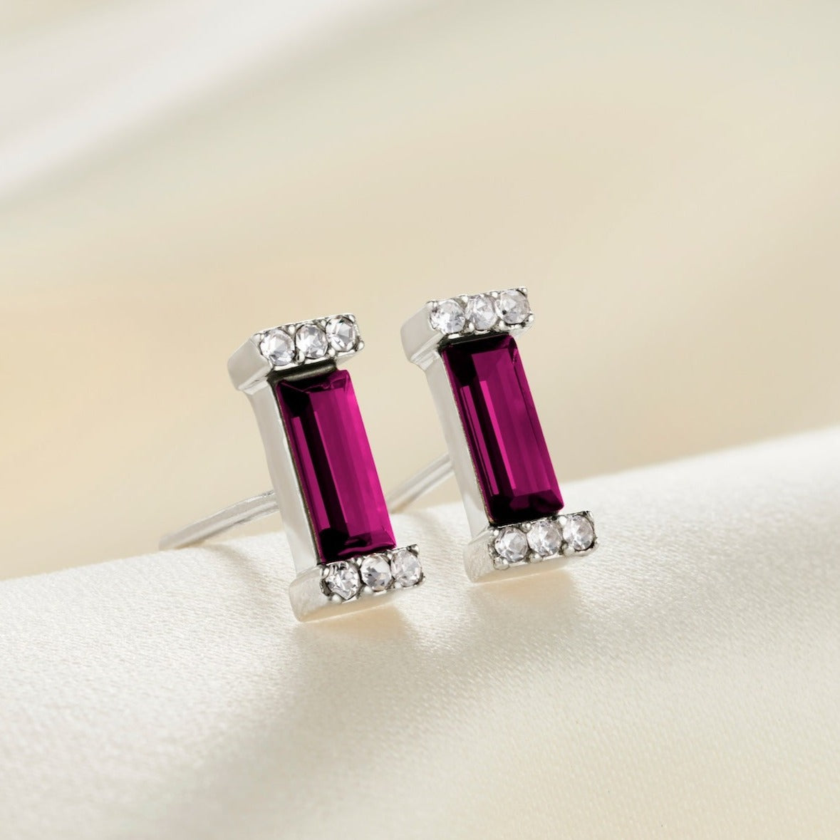 Sterling silver stud post earrings with deep purple amethyst baguette shaped crystals in pavé settings.