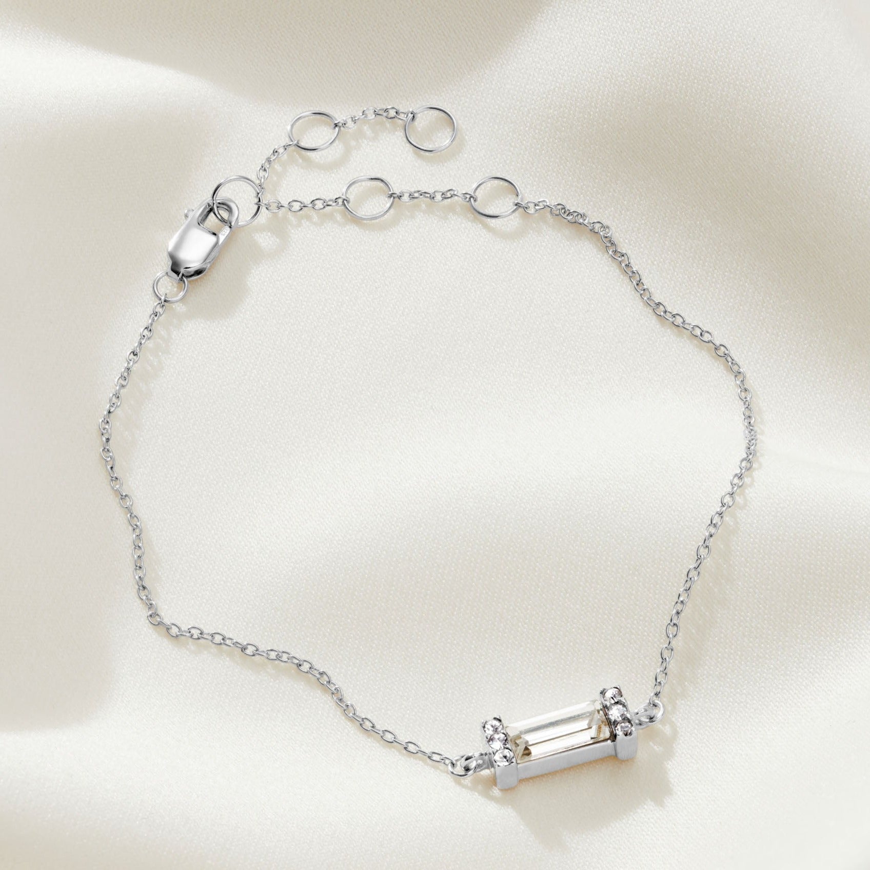 Clear Swarovski crystal baguette stone bracelet in silver in a pavé setting with a dainty fine trace chain with an extender and a lobster claw fastening.