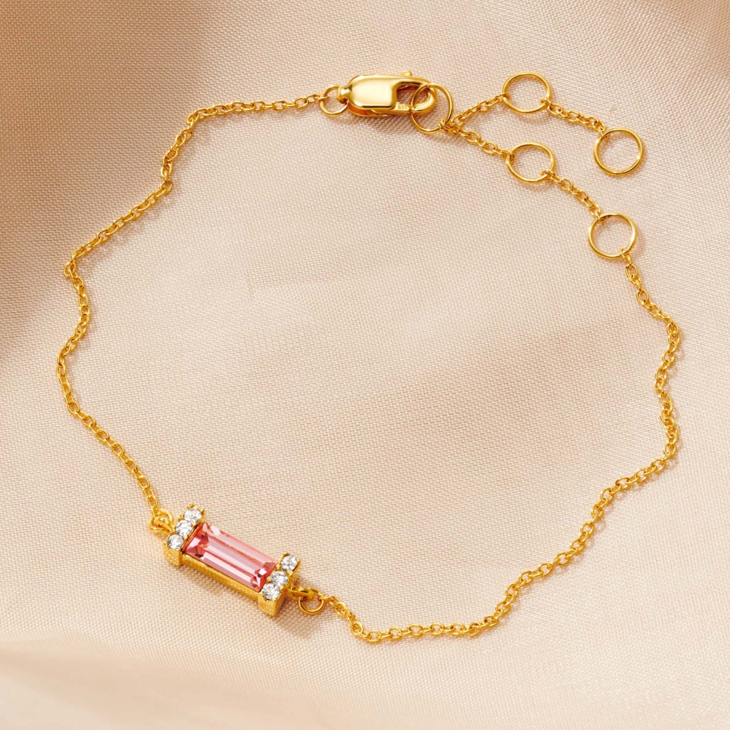 Pink Tourmaline baguette birthstone bracelet in gold with adjustable chain.