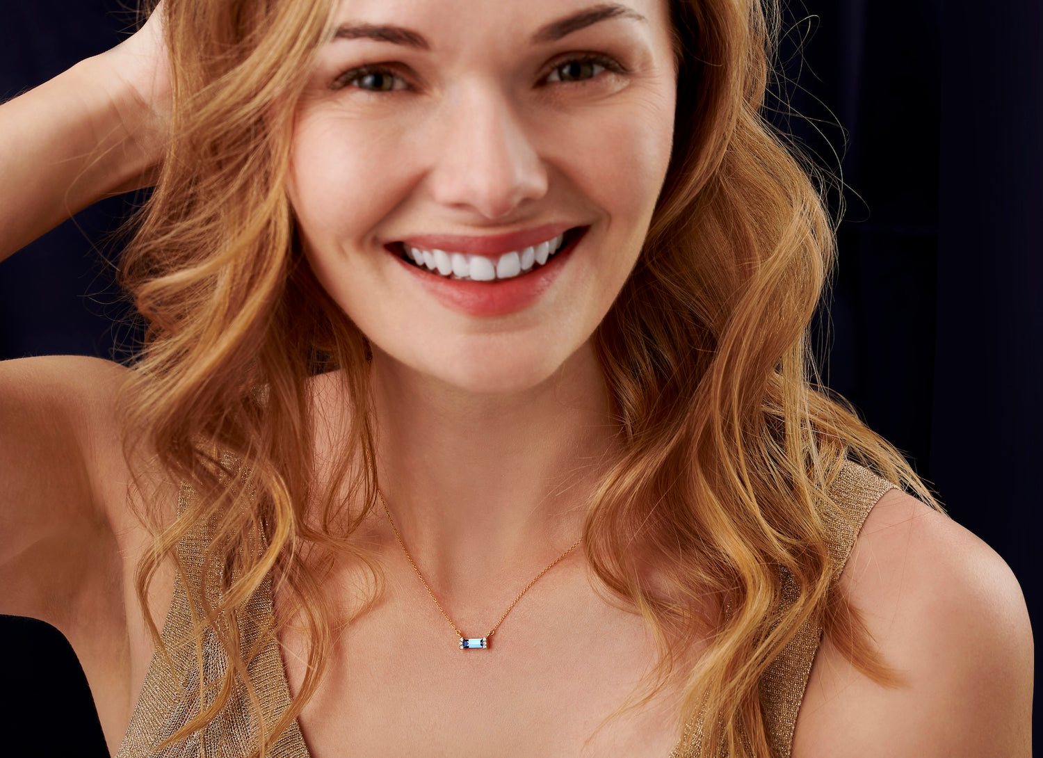 Dainty gold necklace featuring a Swarovski crystal aquamarine birthstone baguette stone set in gold vermeil on a fine trace chain