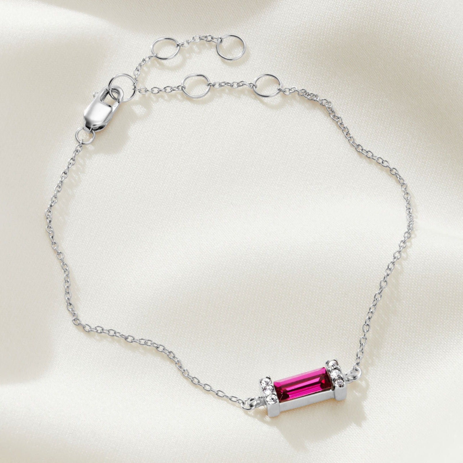 Sterling silver bracelet with a large ruby coloured baguette shaped crystal and crystal pavé detail on a fine sterling silver trace chain with a lobster claw fastening