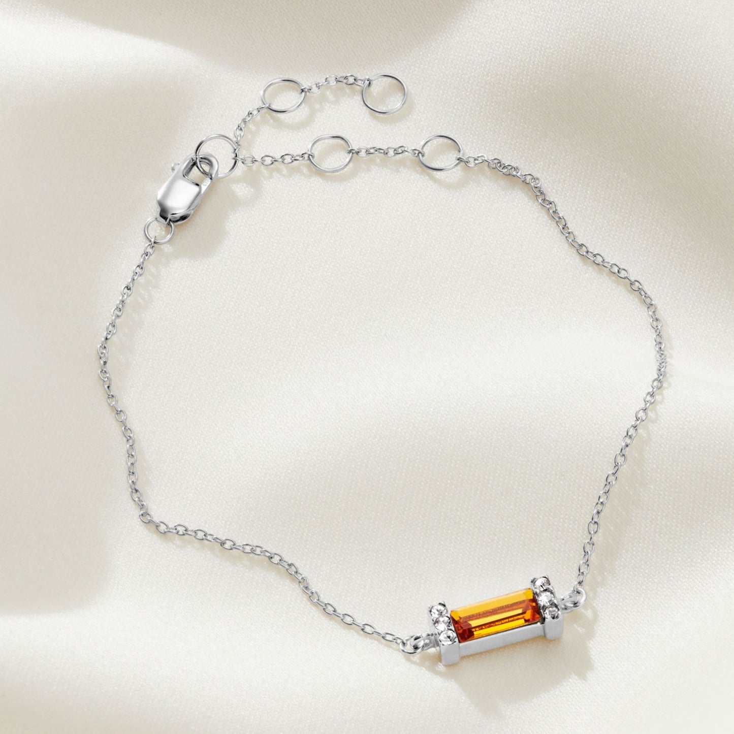 Topaz Swarovski crystal baguette birthstone bracelet with a sterling silver setting on a delicate, fine sterling silver trace chain with a lobster claw fastening.