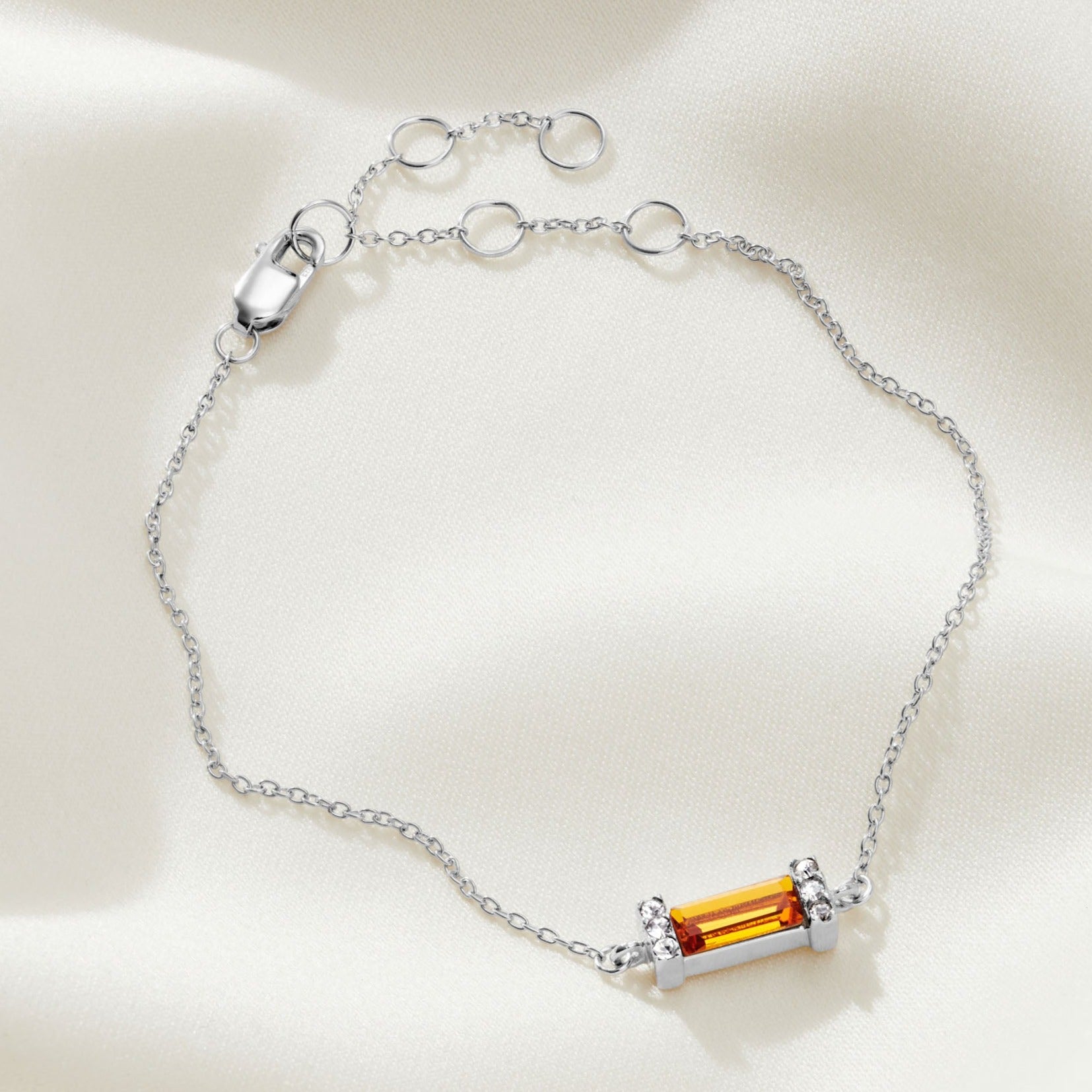 Topaz Swarovski crystal baguette birthstone bracelet with a sterling silver setting on a delicate, fine sterling silver trace chain with a lobster claw fastening.