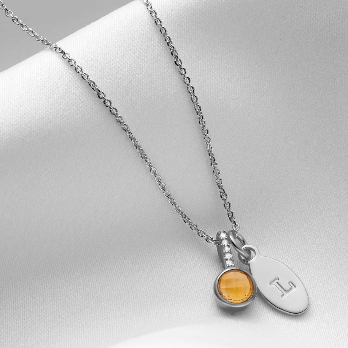 Faceted citrine birthstone pendant with tiny diamonds and initial charm in sterling silver