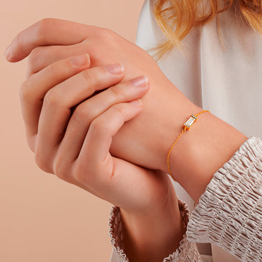Baguette cut crystal bracelet in 18 carat gold vermeil, surrounded by little pavé crystals with an elegant gold trace chain by Claudette Worters.