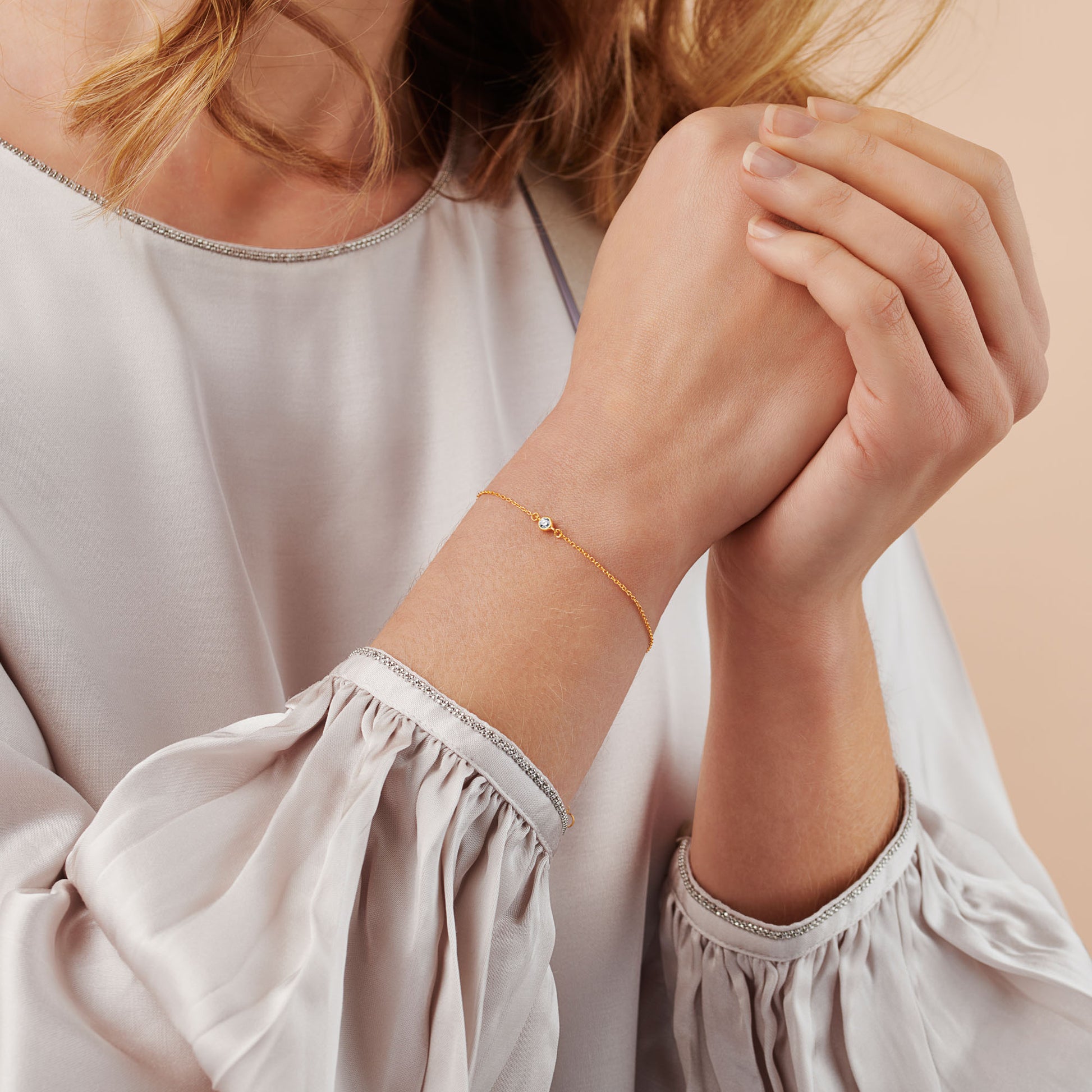 21st birthday diamond bracelet with single diamond in gold bezel on a dainty gold trace chain