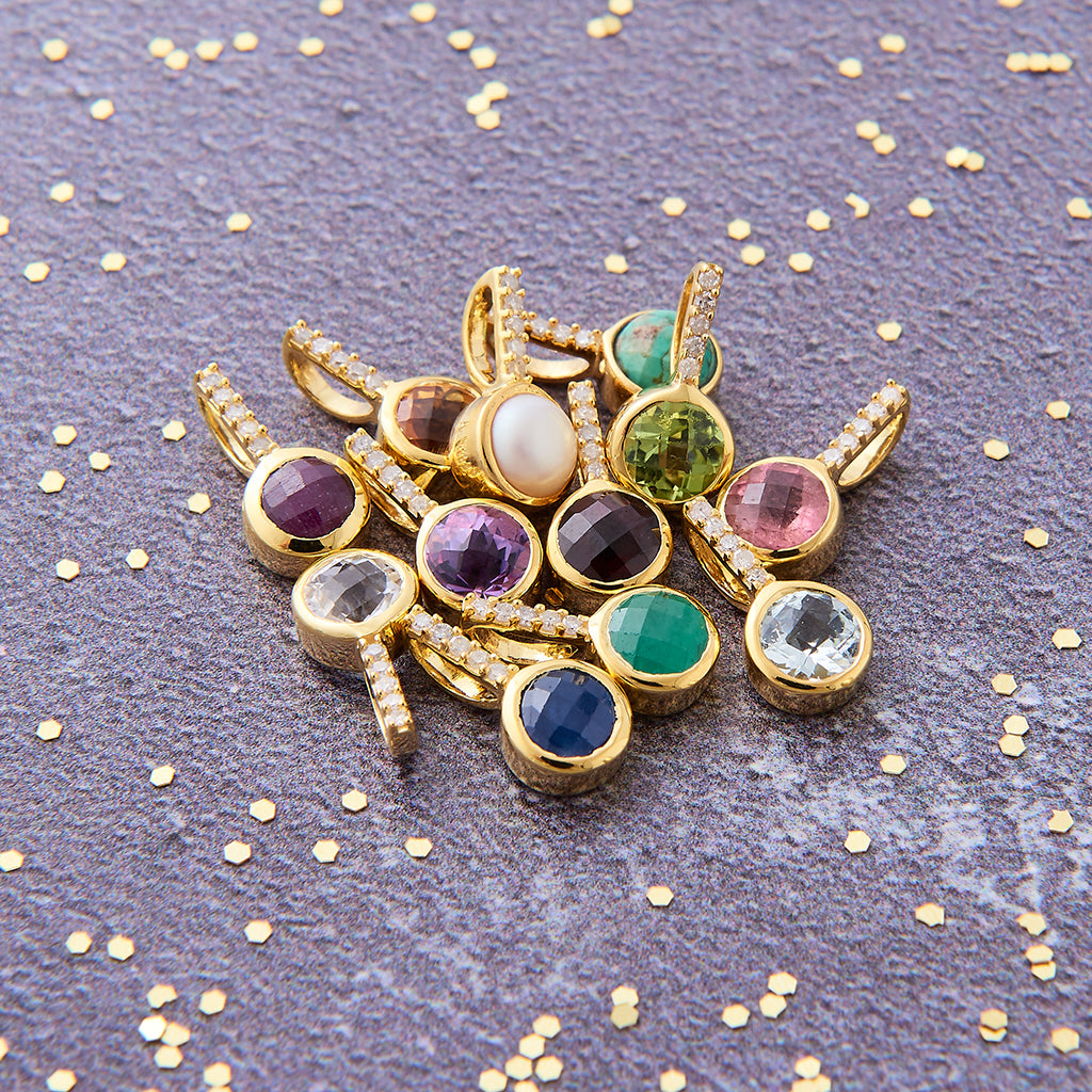 A cluster of twelve multicoloured faceted round birthstone gemstone pendants, each with a row of tiny white diamonds in the bail, set in 18 carat gold vermeil.