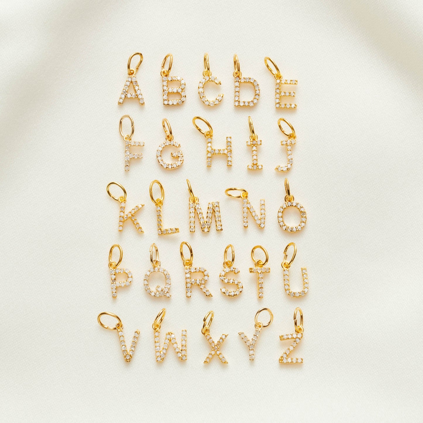 Uppercase gold vermeil letter pendants set with real white diamonds.  Full alphabet shown.