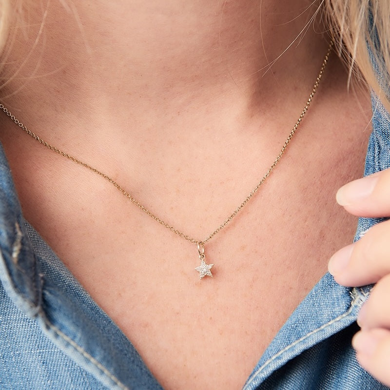 Tiny gold star pendant set with little white genuine diamonds on a dainty fine gauge trace chain by Claudette Worters.