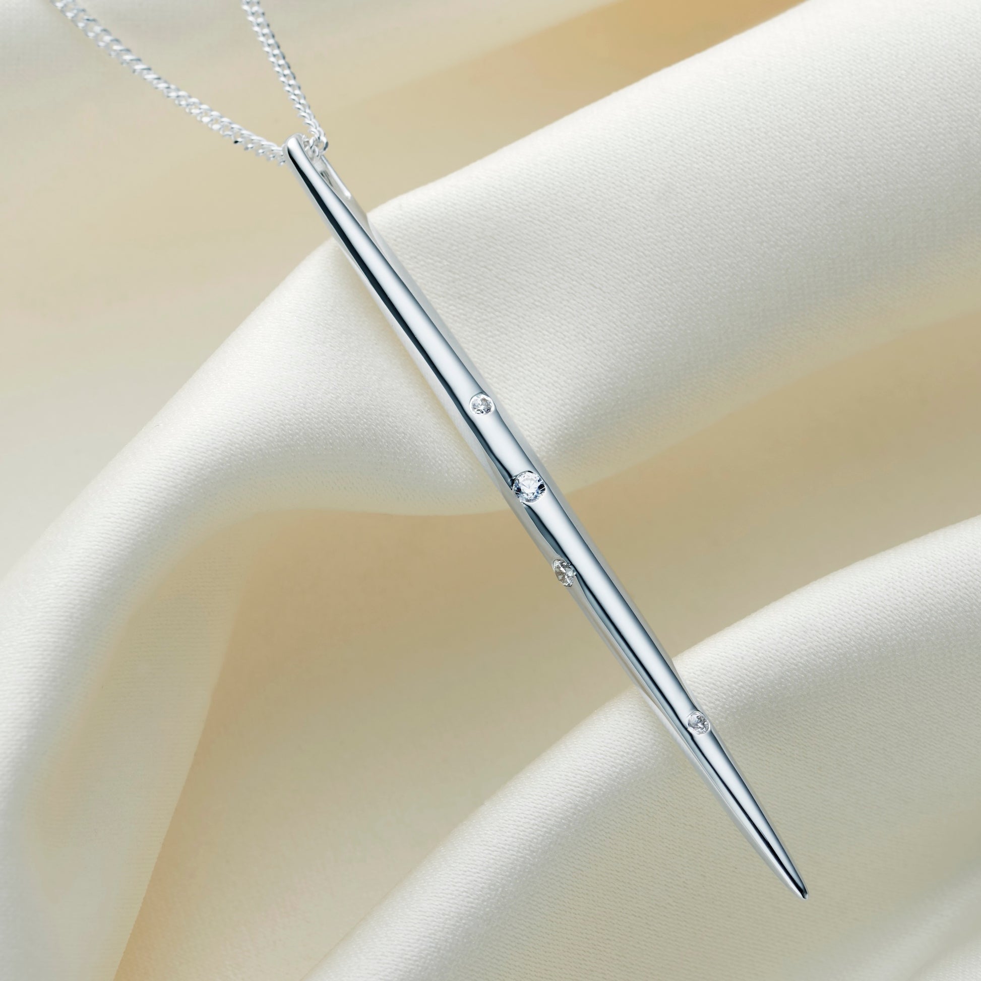 Sterling silver Gemini constellation necklace.  Long thin spike style pendant, set with white crystals in the formation of the Gemini star constellation.