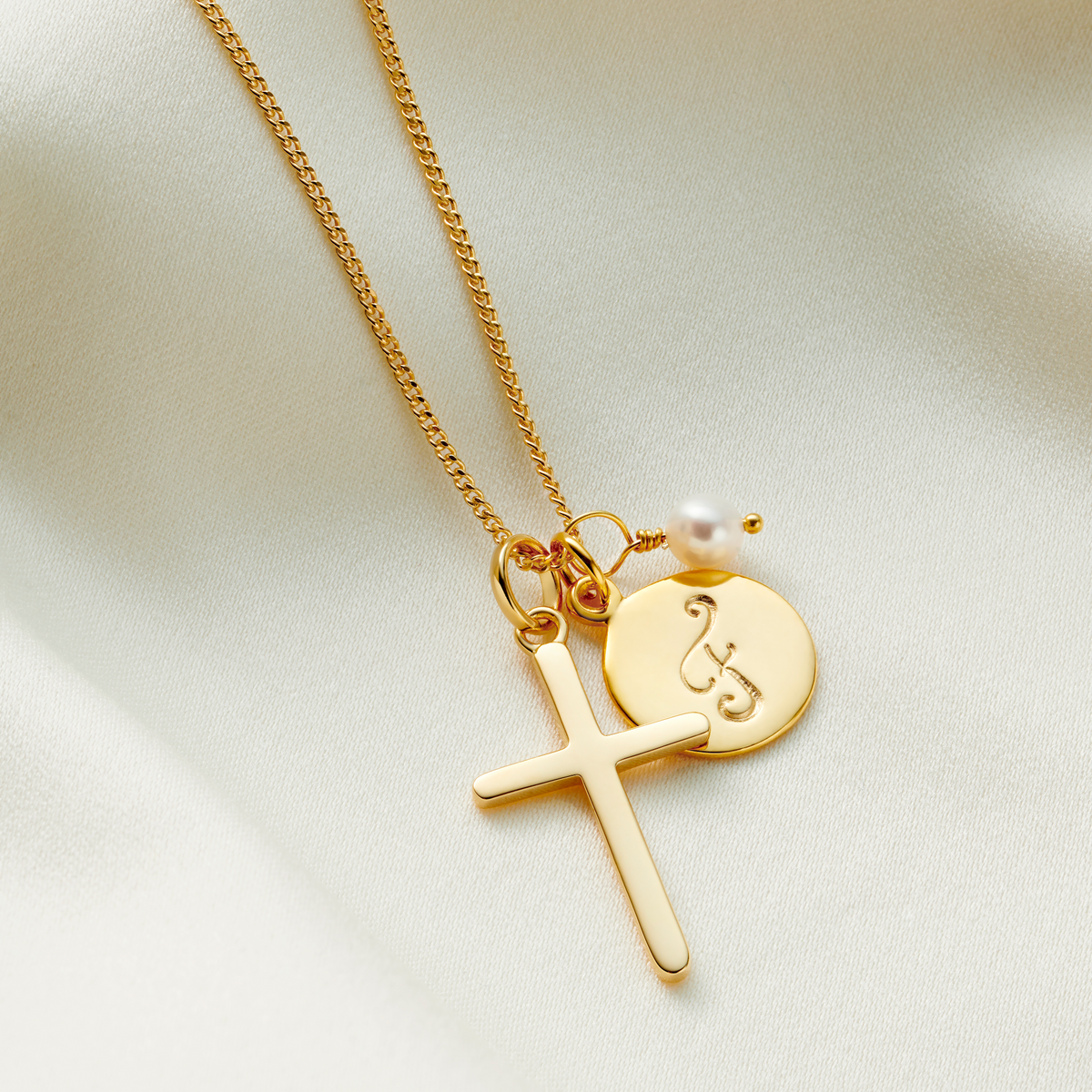 Gold cross necklace personalised with birthstones and initial charm