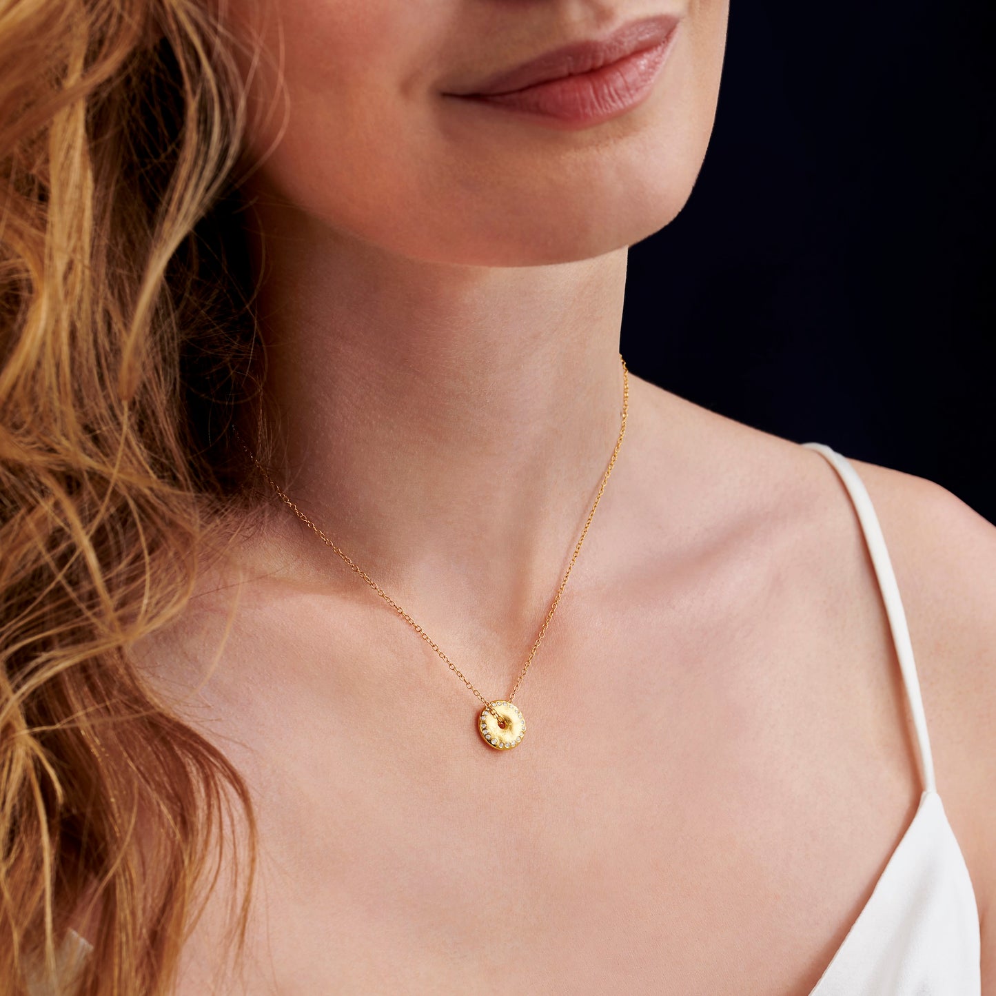  Yellow gold vermeil new Moon pendant necklace by Claudette Worters. Small spinning disc with textured surface resembling the moon, set with tiny natural diamonds along the disc edge, on a fine  gold vermeil chain. 