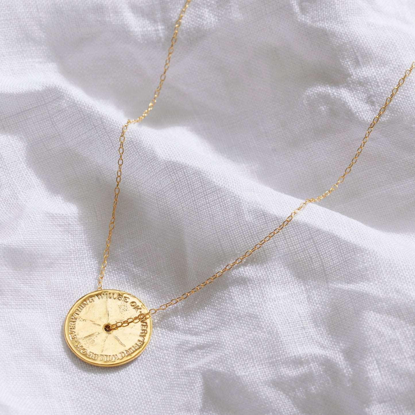 Anxiety necklace in gold on a gold trace chain