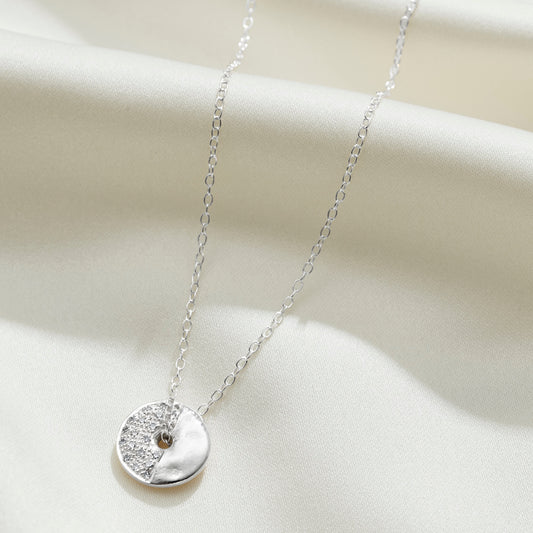 Moon phase necklace in sterling silver with diamonds depicting the third quarter of the moon by Claudette Worters